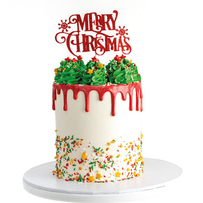 Decorative cake with 'Merry Christmas' topper on a white background